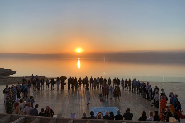 Indigenous water ceremony at sunset on the Dead Sea in Jordan.